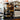 Commercial coffee machine with a coffee cup and branded coffee bags in a coffee shop setting.