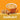 Orange mug of hazelnut coffee with hazelnut-flavored