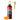 A bottle of Torani Pumpkin Pie flavored syrup with a gold pump dispenser and tow small pumpkins on a white background.