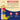 Torani Pineapple syrup bottle with ingredients list on a beige and blue background