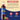 Torani raspberry syrup bottle with ingredients list on a beige and blue background