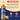 A bottle of Torani vanilla bean sugar free syrup shown on a beige and dark blue graphic background with an ingredients header, ingredient text, and feature icons for plastic PET bottle and natural flavors.