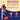 Torani Pomegranate syrup bottle with ingredients list on a beige and blue background