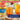 A bottle Torani English Toffee Syrup stands beside two tall glasses of iced tea on a table outdoors. Promotional text overlays read '33% MORE FLAVOR, FOR LESS.