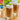 Two glasses of a frothy beverage with a can of torani cane sugar syrup